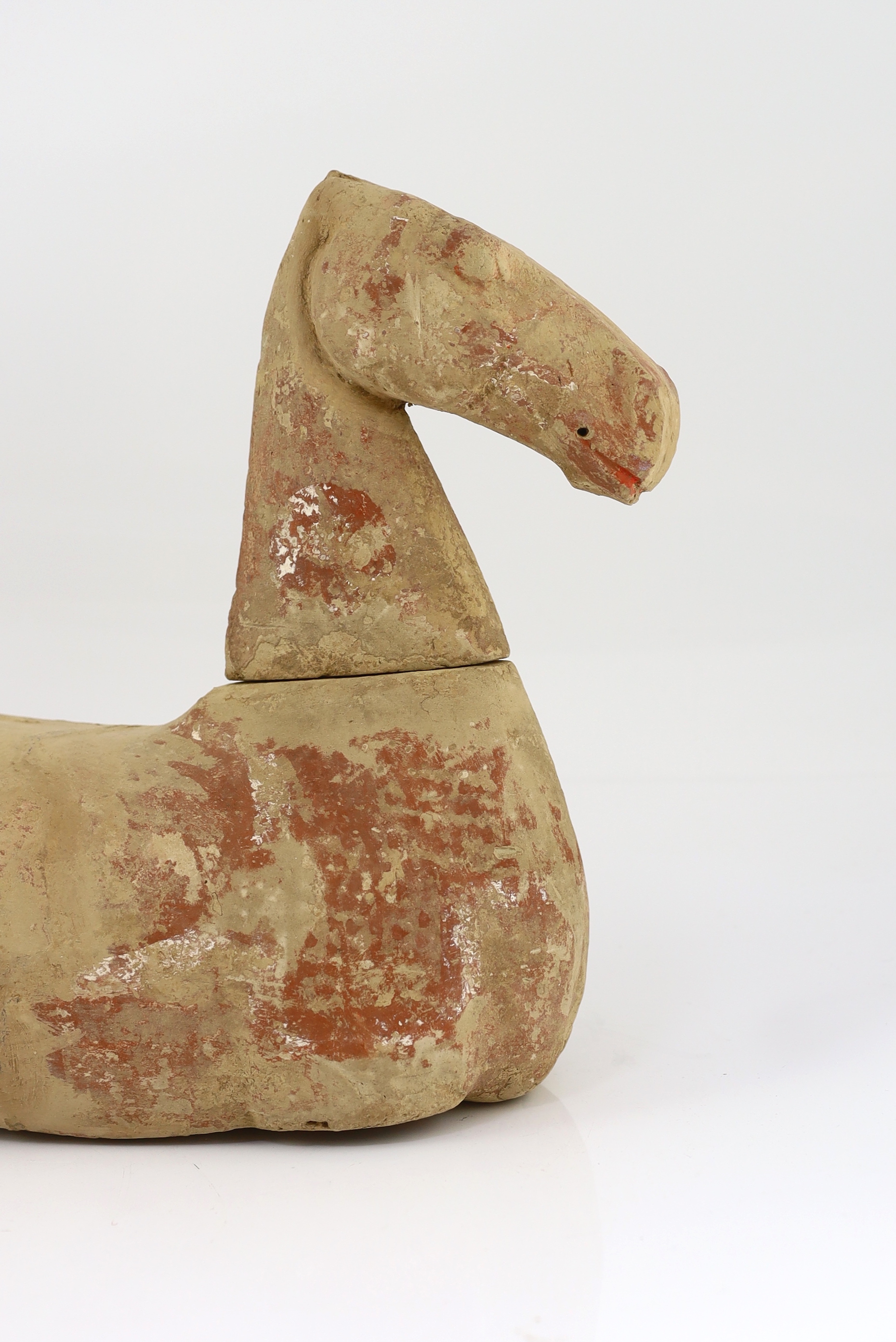 A Chinese buff pottery model of a horse, Han dynasty (206 BC-220 AD)